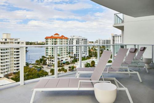 a balcony with chairs and a view of the ocean at AC Hotel by Marriott Fort Lauderdale Beach in Fort Lauderdale