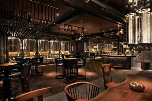 a restaurant with tables and chairs and a bar at Midtown Shangri-La, Hangzhou - around 5 minutes walking distance to West Lake in Hangzhou
