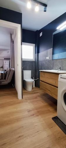 a bathroom with a tub and a toilet and a sink at Casa Petits in Manresa