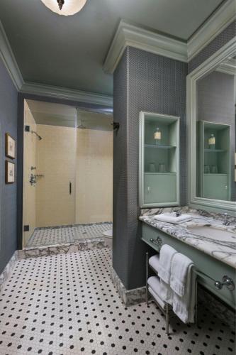 a bathroom with two sinks and a shower at Hotel ICON, Autograph Collection in Houston