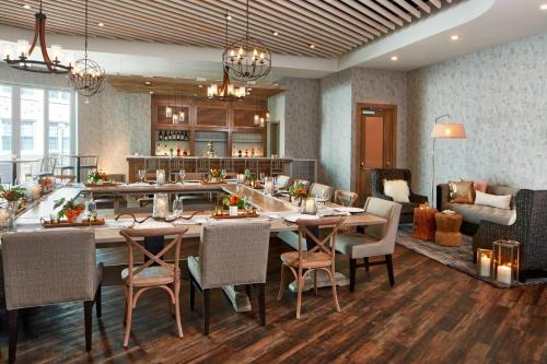 a dining room with a large table and chairs at The Del Monte Lodge Renaissance Rochester Hotel & Spa in Rochester