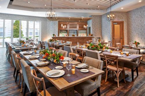 a dining room with long tables and chairs at The Del Monte Lodge Renaissance Rochester Hotel & Spa in Rochester