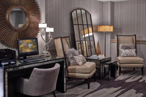 a room with a desk with a computer and two chairs at The Del Monte Lodge Renaissance Rochester Hotel & Spa in Rochester