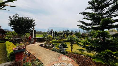a garden with trees and plants and a walkway at Vanhills - Luxury Home Stay in Jim Corbett in Kota Bāgh