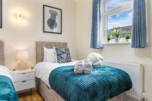 a bedroom with two beds and a window at Lovely 4-BR Home In Leyton - Sleeps 14, Near Tube, Arcade, 100inchTV in London