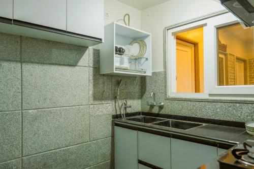 a kitchen with a sink and a mirror at Vanhills - Luxury Home Stay in Jim Corbett in Kota Bāgh