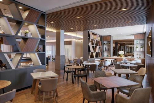 un restaurante con mesas y sillas en AC Hotel by Marriott Saltillo, en Saltillo
