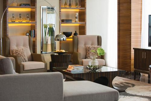 a living room with a couch and chairs and a table at Renaissance Johor Bahru Hotel in Johor Bahru