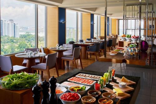a restaurant with a buffet of food on a table at Renaissance Johor Bahru Hotel in Johor Bahru