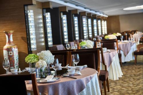 a dining room with tables and chairs with purple table cloth at Renaissance Johor Bahru Hotel in Johor Bahru