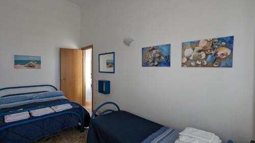 Postel nebo postele na pokoji v ubytování Punta Grande - Scala dei Turchi