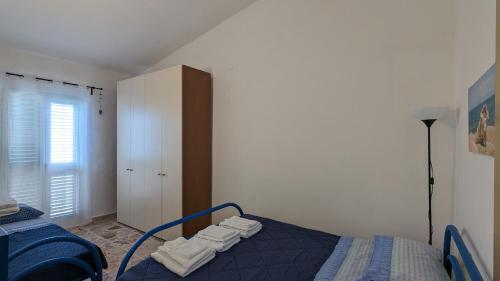 a bedroom with a bed with towels on it at Punta Grande - Scala dei Turchi in Realmonte