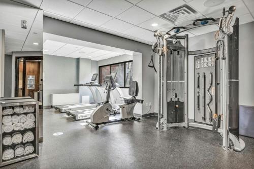 a gym with treadmills and elliptical machines at Delta Hotels by Marriott Mount Pleasant in Racine