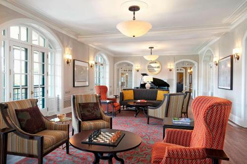 a living room filled with chairs and a table at The Algonquin Resort St. Andrews by-the-Sea, Autograph Collection in Saint Andrews
