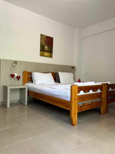 a large wooden bed in a room with a table at ERA Studios2 in Skiathos