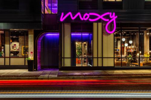 a moxy sign on the side of a building at MOXY Minneapolis Uptown in Minneapolis