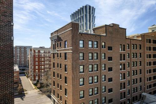 a tall brick building with a tall tower on top of it at AC Hotel by Marriott St Louis Central West End in Saint Louis