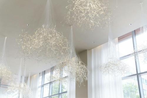 a room with two chandeliers hanging from the ceiling at AC Hotel by Marriott Bethesda Downtown in Bethesda