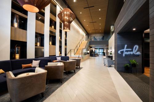 a lobby with couches and chairs in a building at Elliot Park Hotel, Autograph Collection in Minneapolis