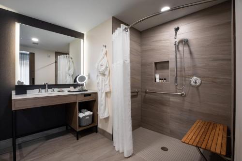a bathroom with a shower and a sink at Elliot Park Hotel, Autograph Collection in Minneapolis