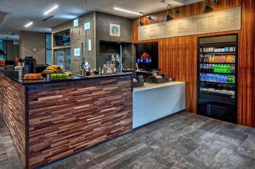 a bar in a restaurant with a counter with food at Courtyard by Marriott Dulles Airport Herndon in Herndon