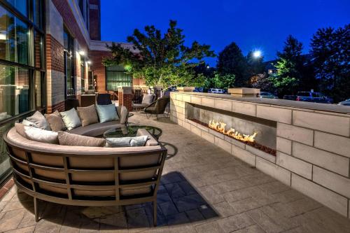 a patio with a couch and a fire place at Courtyard by Marriott Dulles Airport Herndon in Herndon