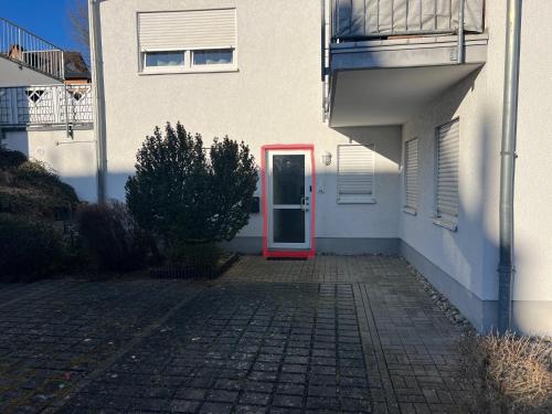 a red door on the side of a white building at APARTMENT in Altendiez in Altendiez