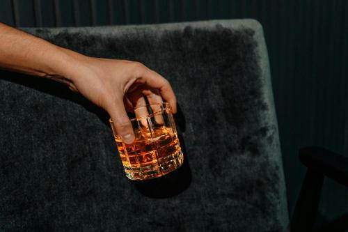 a person holding a drink in a glass at Melbourne Marriott Hotel in Melbourne