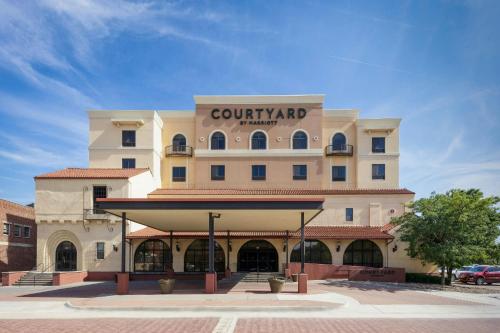a large building with a sign on top of it at Courtyard by Marriott Wichita at Old Town in Wichita