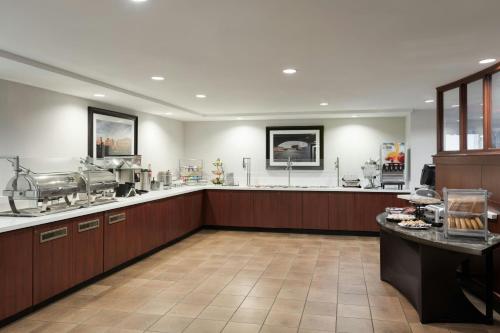 a large kitchen with wooden cabinets and a counter at Courtyard by Marriott Wichita at Old Town in Wichita