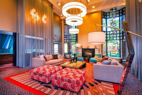 a large living room with a couch and a table at Courtyard by Marriott Dulles Town Center in Sterling
