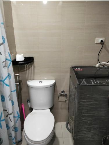 a bathroom with a white toilet in a room at VSV Luxury Family Suite staycation Moa shore2 tower2 unit1122 in Manila