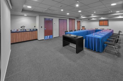 a conference room with a long blue table and chairs at City Express by Marriott Ciudad de México Plaza Central in Mexico City