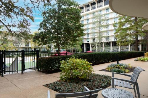 a park with two benches and a building at Marriott St. Louis Airport in Edmundson