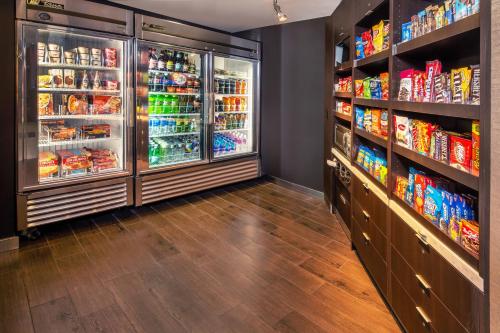 a grocery store aisle with a refrigerator full of food at Courtyard Dunn Loring Fairfax in Merrifield