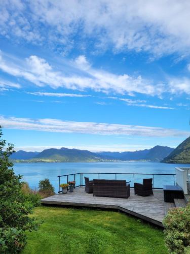 a deck with a view of a body of water at Irenegarden - Fjord view holiday home in Lauvstad