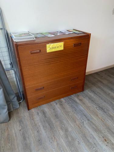 a wooden dresser with a yellow sign on it at Les Papillons Studio La Foulnerie avec cour autonome 61270 Rai proche 61300 l'Aigle -Sanateflo- in Rai-sur-Rîle