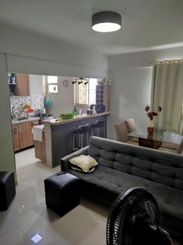 a living room with a couch and a kitchen at Apto Pedreira para círio e cop30 in Belém