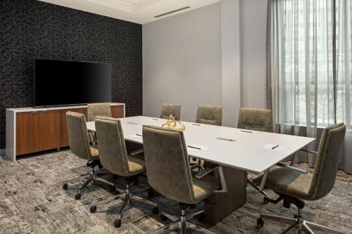 a conference room with a white table and chairs at Courtyard by Marriott St Paul Downtown in Saint Paul