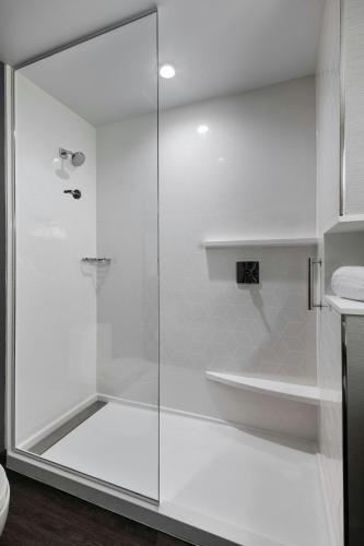 a shower with a glass door in a bathroom at Courtyard by Marriott St Paul Downtown in Saint Paul