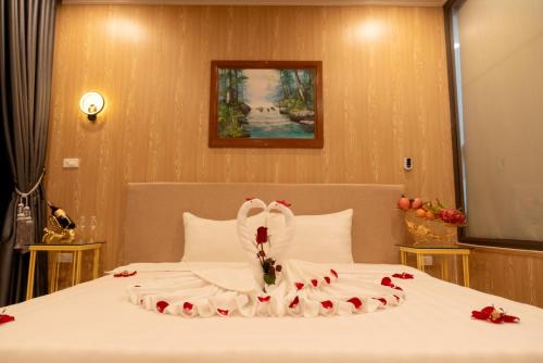 a bedroom with a bed with a wedding dress on it at Sunny Garden Riverside Hotel Ninh Binh in Ninh Binh