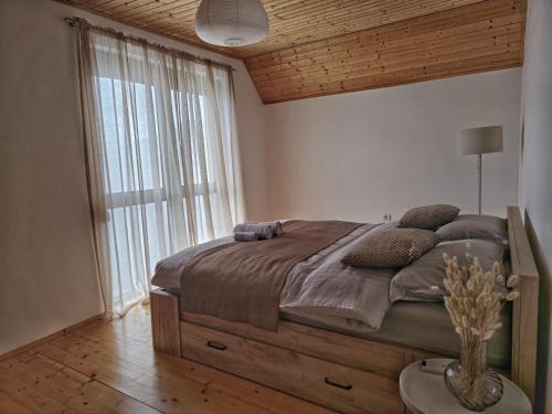 ein Schlafzimmer mit einem großen Bett und einem großen Fenster in der Unterkunft Best View Kolasin in Kolašin