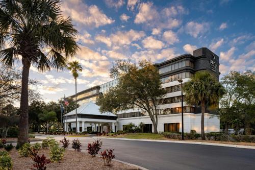 a rendering of a building with a palm tree at Delta Hotels by Marriott Jacksonville Deerwood in Jacksonville