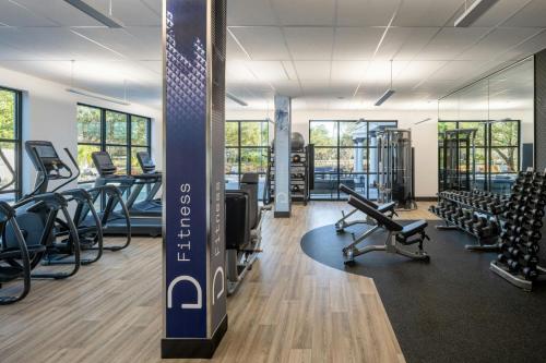 a gym with rows of chairs and treadmills at Delta Hotels by Marriott Jacksonville Deerwood in Jacksonville