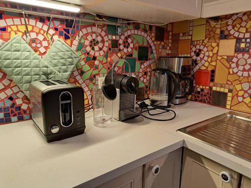 a kitchen counter with a toaster and a sink at Mino Apartment in Bludenz