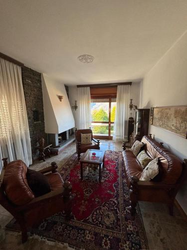 a living room with two couches and a table at Casa Rosa in Cassina Valsassina