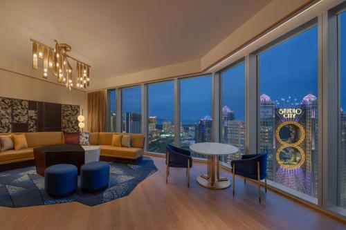 a living room with a view of the chicago skyline at W Macau - Studio City in Macau