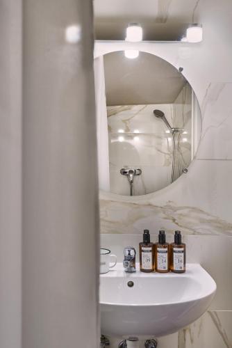 a bathroom with a sink and a mirror at Hotel Suisse in Strasbourg