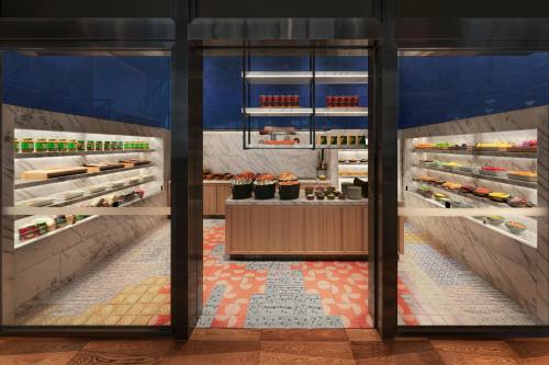 a kitchen with an open refrigerator with food at W Macau - Studio City in Macau