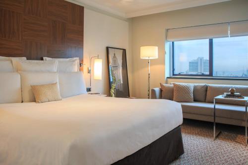 a hotel room with a large bed and a couch at Renaissance São Paulo Hotel in Sao Paulo